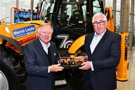 JCB Chairman Anthony Bamford (left) presents Morris Leslie with a special scale model version of the Platinum Edition backhoe loader produced to mark the JCB machine’s 70th birthday. 