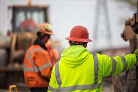 Construction supervisor reviewing construction work