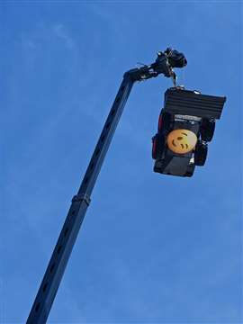 A Bobcat skidsteer loader suspended high above the company’s stand, complete with winking face emoji…