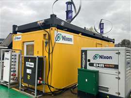 Foto mostrando um sistema de armazenamento de energia em baterias da Himoinsa ao lado de uma cabine de obra. (Imagem: Nixon Hire)