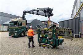 Electric Palfinger loader crane unloading a Hoeflon mini crawler crane from the back of a Volvo FH 8x2 rigid truck