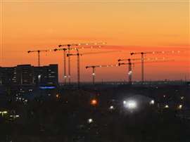 Sunst in Frisco, Texas with Uperio Zoomlion cranes silhouetted.