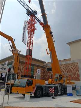 big yellow Liebherr LTM 1230-5.1 wheeled mobile hysraulic telescopic boom crane at the Bauma ConExpo India trade show near Delhi, India, September 2026