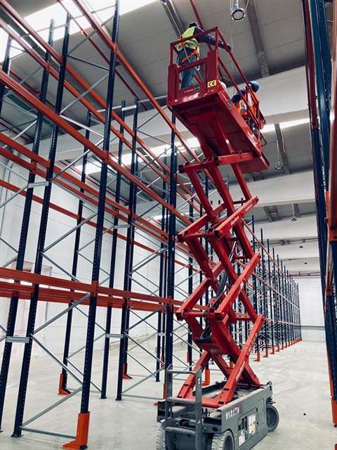 Loxam scissor lift in warehouse