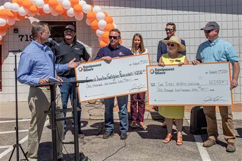 Charity representatives with the cheques from EquipmentShare