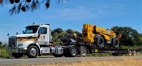 H&E Equipment Services truck transporting a JCB telehandler