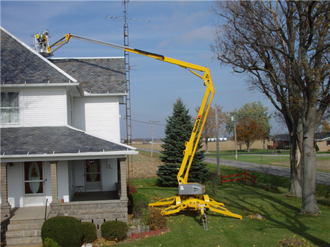 Haulotte trailer mount carrying out roof maintenance.