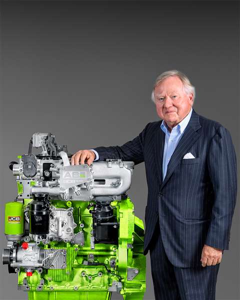 Lord Bamford, chairman of JCB, stands next to JCB's hydrogen internal combustion engine