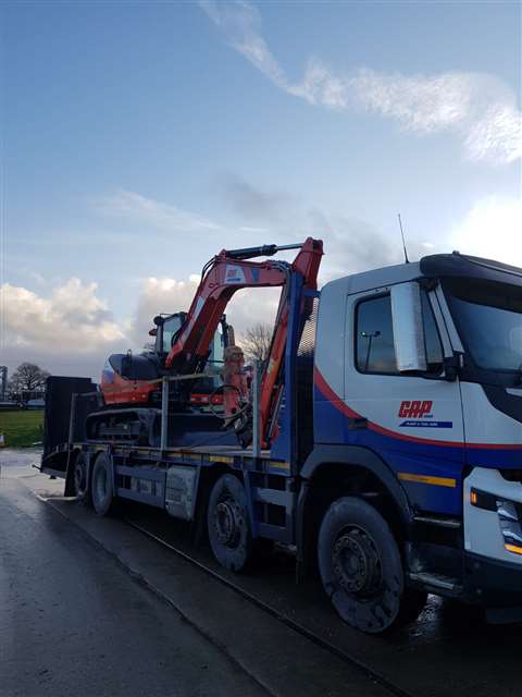 A truck delivers a Kubota KX080-4 to GAP Hire Solutions