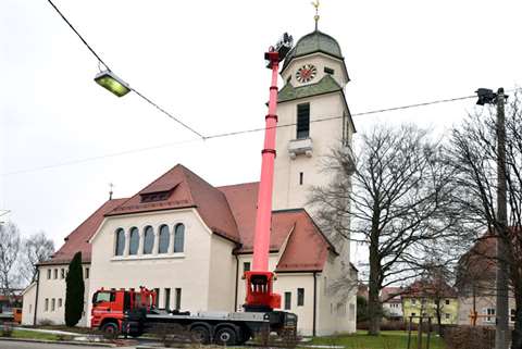 Ferdinand Scheurer mends the storm damaged Protestant Christ Church in Eislingen, Germany.