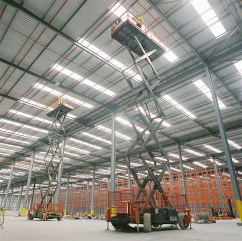 Two AFI-owned scissor lifts at work in a UK logistics centre.